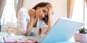 young-frustrated-woman-working-from-home-office-front-laptop-suffering-from-chronic-daily-headaches-treatment-online-appointing-medical-consultation-electromagnetic-radiation-sick-pay